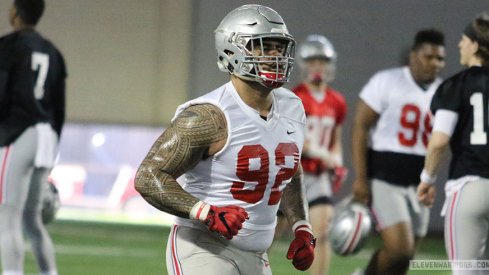 Haskell Garrett (92) running with quarterbacks Dwayne Haskins (7) and Joe Burrow (10) in the background.