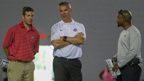 Director of player development Mark Pantoni, head coach Urban Meyer and assistant director of player personnel Eron Hodges
