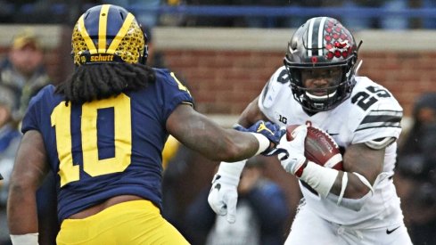Nov 25, 2017; Ann Arbor, MI, USA; Ohio State Buckeyes running back Mike Weber (25) rushes at Michigan Wolverines linebacker Devin Bush (10) in the second half at Michigan Stadium. Mandatory Credit: Rick Osentoski-USA TODAY Sports