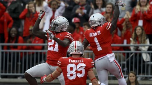 Parris Campbell celebrates one of his two touchdowns with Johnnie Dixon and Luke Farrell.