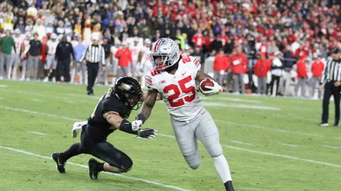 Mike Weber escapes an attempted tackle from Purdue's Thieneman