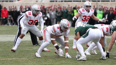 Chase Young, Malik Harrison, and Tuf Borland eye their prey. 