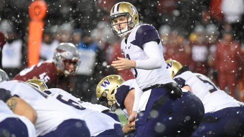 Jake Browning reads the defense before taking snap in the snow. 