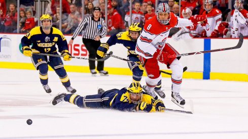 Buckeye forward Dakota Joshua speeds after the puck while the Michigan Wolverines look on.