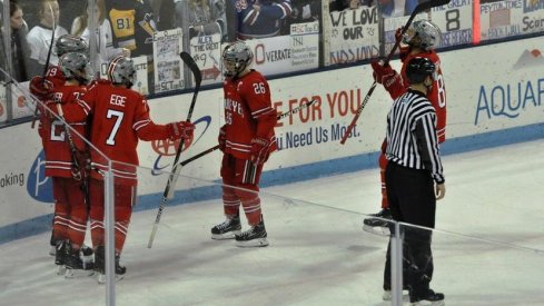 The men's hockey Buckeyes celebrate a goal in a 6-4 win over the Penn State Nittany Lions