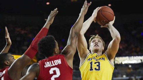 Ignas Brazdeikis shoots over Ohio State's Kaleb Wesson and Musa Jallow