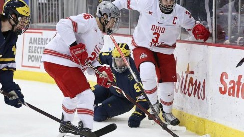 Buckeye captains Mason Jobst and Sasha Larocque battle Michigan in a game at Value City Arena.