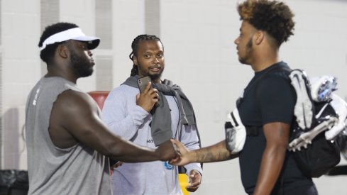 Brandon Collier (middle) and Tyrese Owusu-Bediako (right) meet Robert Landers at Thursday's Ohio State football camp.