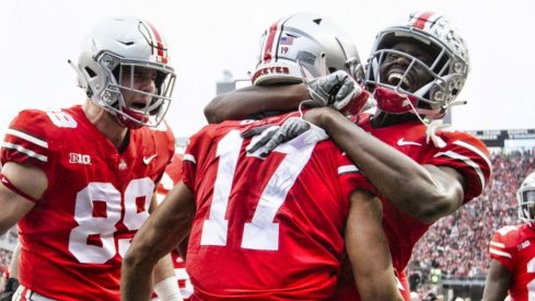 Nov 24, 2018; Columbus, OH, USA; Ohio State Buckeyes wide receiver Chris Olave (17) is congratulated by tight end Luke Farrell (89) and wide receiver Binjimen Victor (9) after scoring a touchdown against the Michigan Wolverines at Ohio Stadium. Mandatory Credit: Greg Bartram-USA TODAY Sports