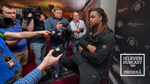 Ohio State defensive lineman Chase Young, surrounded by reporters