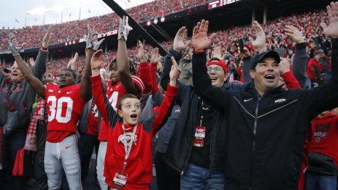 Ryan Day celebrates with Ohio State players and fans after the 2018 win over Michigan.