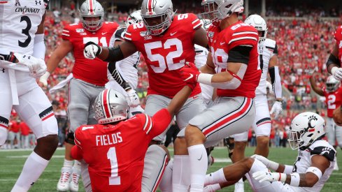 Fields is assisted after a touchdown. 