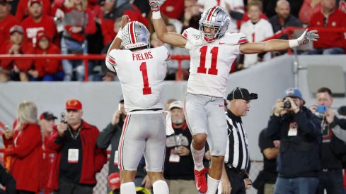 Justin Fields and Austin Mack celebrate a touchdown.