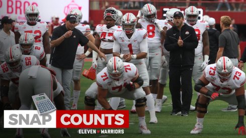 Justin Fields takes a snap from Josh Myers pregame.