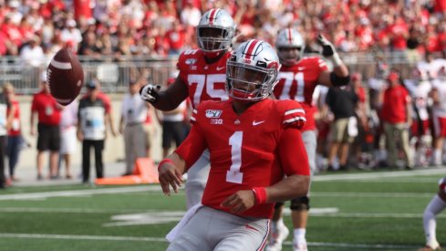 Justin Fields celebrates after running for a touchdown.