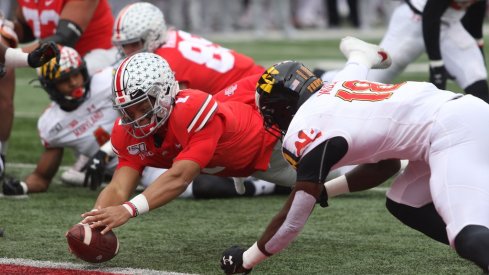 Justin Fields dives for the end zone. 