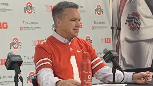 Chris Holtmann rocks a football jersey.