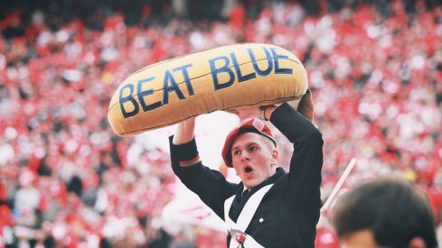 Band member holds the beat blue banana.