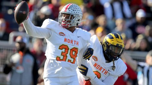 Malik Harrison celebrates his interception in the Senior Bowl.