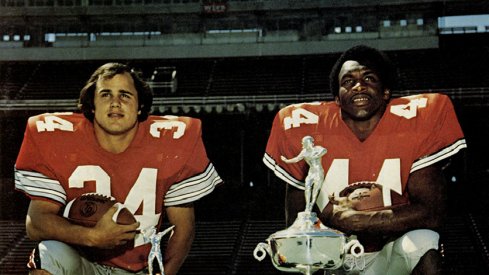 Running backs Jeff Logan and Archie Griffin pose with their trophies.