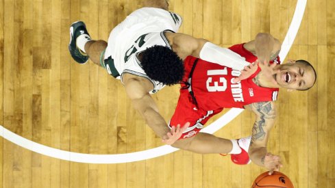 Mar 8, 2020; East Lansing, Michigan, USA; Ohio State Buckeyes guard CJ Walker (13) is defended by Michigan State Spartans forward Malik Hall (25) during the second half a game at the Breslin Center. Mandatory Credit: Mike Carter-USA TODAY Sports