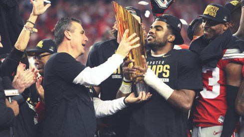 Urban Meyer and Ezekiel Elliott celebrate with the national championship trophy.