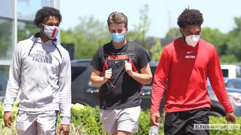 Garrett Wilson and Chris Olave report to the Woody Hayes Athletic Center.