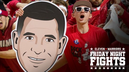 Rutgers fans hold up a Greg Schiano face as they cheer on their team. Seton Hall Basketball at Rutgers in Piscataway, NJ on 12/12/19