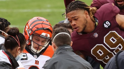 Nov 22, 2020; Landover, Maryland, USA; Cincinnati Bengals quarterback Joe Burrow (9) shakes hands with Washington Football Team defensive end Chase Young (99) prior to being carted off the field after injuring his left knee in the third quarter at FedExField. Mandatory Credit: Geoff Burke-USA TODAY Sports