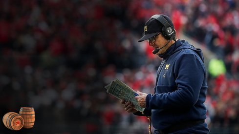 Michigan head coach Jim Harbaugh looks down at his notes during a timeout in the second half against Ohio State at Ohio Stadium in Columbus, Ohio, Saturday, Nov. 24, 2018. Jim Harbaugh