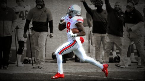 Ohio State Buckeyes running back Trey Sermon (8) scores a touchdown during the third quarter of a NCAA Division I football game between the Michigan State Spartans and the Ohio State Buckeyes on Saturday, Dec. 5, 2020 at Spartan Stadium in East Lansing, Michigan. Ohio State Buckeyes At Michigan State Spartans