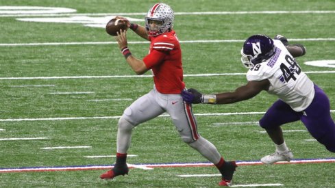 Ohio State quarterback Justin Fields escapes a Northwestern defender