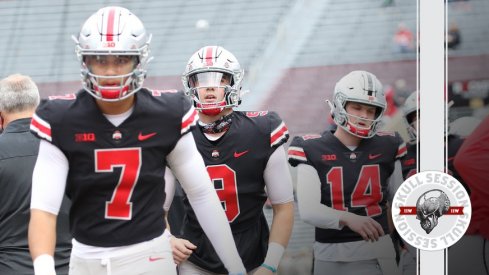 Ohio State quarterbacks walk on the field.