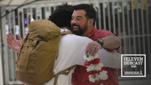 Ohio State head coach Ryan Day hugs a recruit