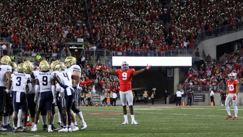 Zach Harrison takes in the night crowd at Ohio Stadium. 