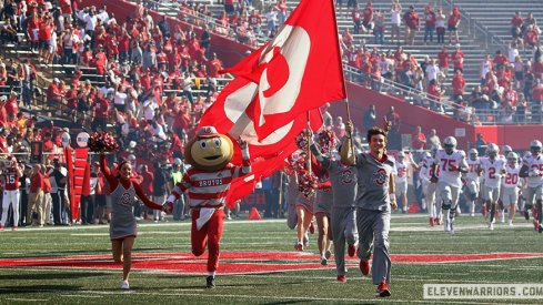 Ohio State cheerleaders run onto the field at Rutgers