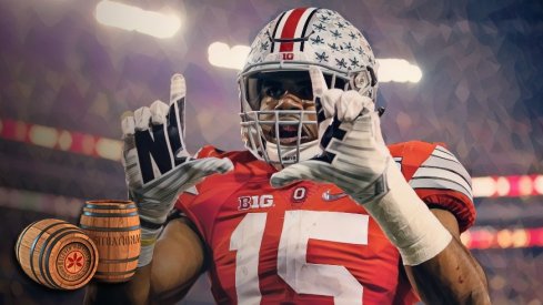 Ohio State Buckeyes running back Ezekiel Elliott (15) celebrates scoring a touchdown on a 33-yard run during the first quarter of the College Football Playoff National Championship against the Oregon Ducks at AT&T Stadium in Arlington, Texas on Jan. 12, 2015. 