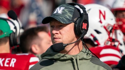 Nov 6, 2021; Lincoln, Nebraska, USA; Nebraska Cornhuskers head coach Scott Frost (right) looks onto the field during the second quarter against the Ohio State Buckeyes at Memorial Stadium. Mandatory Credit: Dylan Widger-USA TODAY Sports