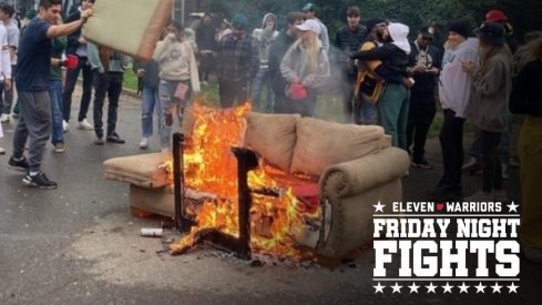 A small crowd gathers as a couch is burned on Harrison Road near Elm Street in East Lansing on Saturday, Oct. 30, 2021, after Michigan State's 37-33 football victory over Michigan.