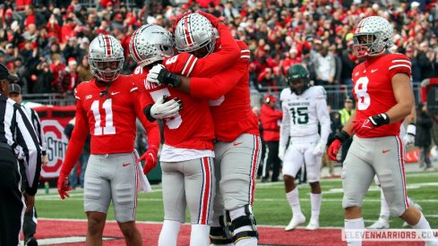 Garrett Wilson and Dawand Jones embrace after a score.