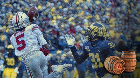 Nov 30, 2019; Ann Arbor, MI, USA; Ohio State Buckeyes wide receiver Garrett Wilson (5) makes a reception on Michigan Wolverines defensive back Vincent Gray (31) in the first half at Michigan Stadium. Mandatory Credit: Rick Osentoski-USA TODAY Sports