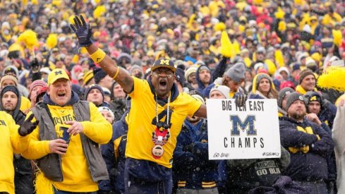 Michigan fan Gerald Blanc celebrates the Wolverines' 42-27 win over the Ohio State Buckeyes during the NCAA football game at Michigan Stadium in Ann Arbor on Saturday, Nov. 27, 2021.