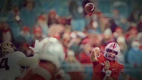 Ohio State Buckeyes quarterback C.J. Stroud (7) throws to wide receiver Chris Olave (2) during the second quarter of the NCAA football game at Ohio Stadium in Columbus on Saturday, Nov. 13, 2021.