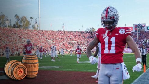 Sat., Jan. 1, 2022; Pasadena, California, USA; Ohio State Buckeyes wide receiver Jaxon Smith-Njigba (11) flexes after scoring a touchdown during the second quarter of the 108th Rose Bowl Game between the Ohio State Buckeyes and the Utah Utes at the Rose Bowl.