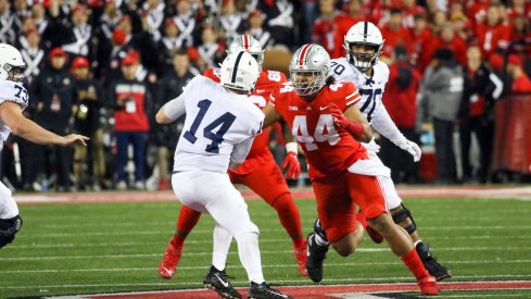 Ohio State defensive end J.T. Tuimoloau pursues Penn State quarterback Sean Clifford