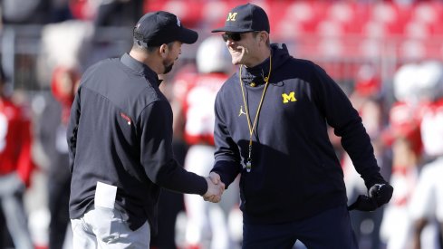 Ohio State head football coach Ryan Day shakes hands with Michigan head football coach Jim Harbaugh