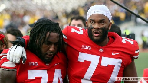 Donovan Jackson and Paris Johnson leave the field after losing to Michigan