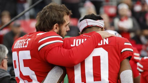 Noah Ruggles and Xavier Johnson leave the field following No. 2 Ohio State's 45-23 loss to No. 3 Michigan