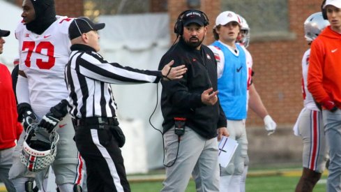 Ohio State head football coach Ryan Day talks with a ref