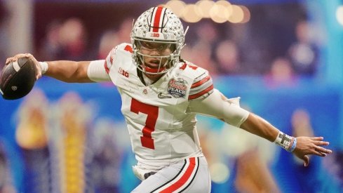 Dec 31, 2022; Atlanta, Georgia, USA; Ohio State Buckeyes quarterback C.J. Stroud (7) evades pressure from the Georgia Bulldogs during the second quarter of the 2022 Peach Bowl at Mercedes-Benz Stadium. Mandatory Credit: Dale Zanine-USA TODAY Sports